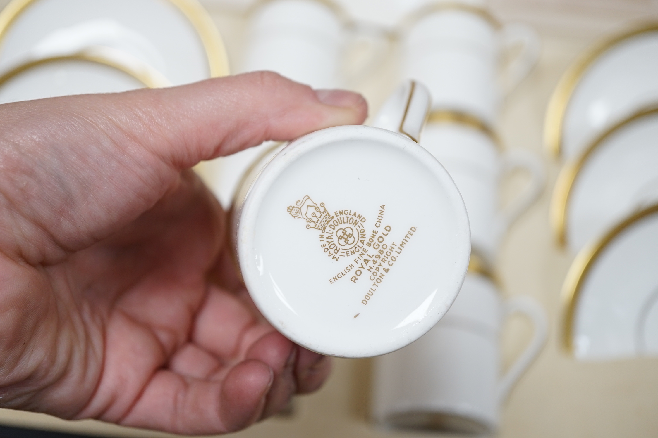 A cased Royal Doulton Royal gold pattern set of coffee cans and saucers